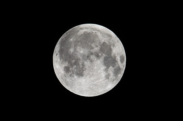 A sharp, detailed close-up of the full moon isolated against a pitch-black night sky. The craters, seas (mare), and surface texture are clearly visible.