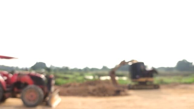  Blurred backhoe is leveling the ground , Chiangmai Thailand.