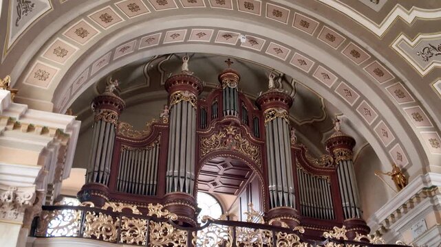 Timisoara landmark interior featuring the historic organ of Saint George&rsquo;s Catholic Cathedral, framed by detailed architectural elements.