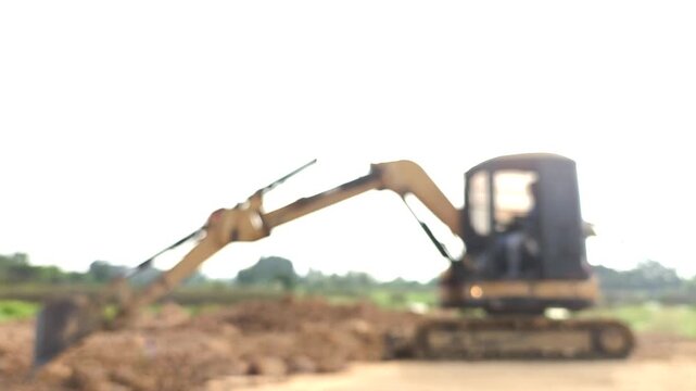  Blurred backhoe is leveling the ground , Chiangmai Thailand.