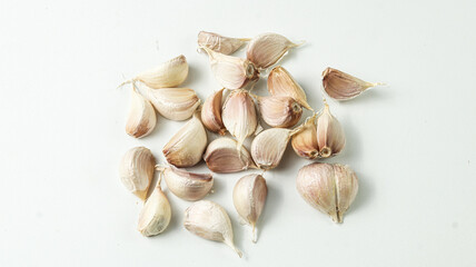 Fresh garlic cloves on a white background. Perfect for culinary or health content.
