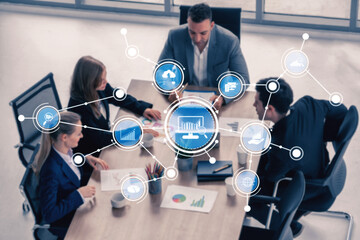 A group of diverse professionals engages in a productive meeting, utilizing technology and data visualization to enhance strategic planning and decision-making processes. Tessel