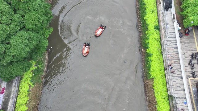 The rafting boat stops in the murky water to restore the team members' strength for a crazy adventure down the city's central river.