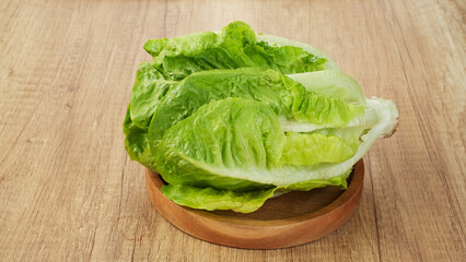 Fresh green romaine lettuce on a wooden background