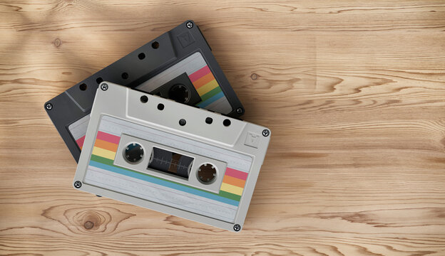 Retro audio cassette tapes on wooden surface top view