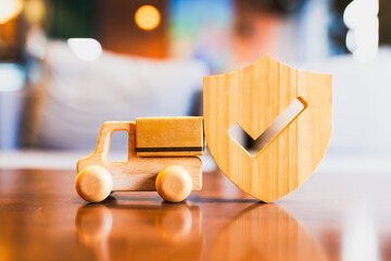 Wooden delivery truck and shield with checkmark symbolizing secure shipping, trusted logistics, parcel protection, reliable transportation, and e-commerce safety assurance concept.