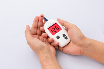 hand of people check diabetes and high blood glucose monitor with digital pressure gauge. Healthcare and Medical concept	
