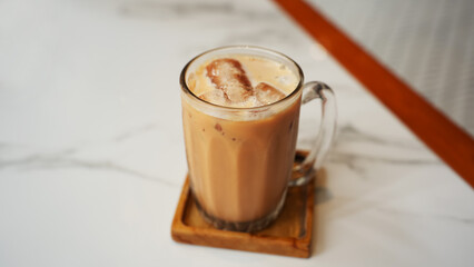 Iced Milk Tea or Es Teh Tarik in a cafe