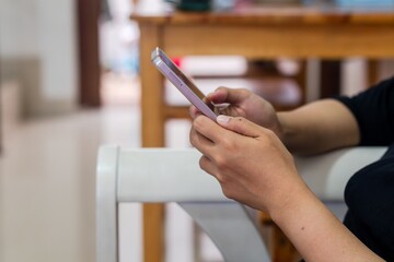 A woman using smartphone while sitting at home