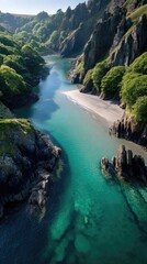 Panoramic Aerial View Of A Rugged Coastline With A Crystal Clear Turquoise River Flowing Into The Ocean Under Bright Sunlight