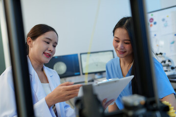 Researchers are working with a 3D printer to print clear, white plastic models using cutting-edge,...