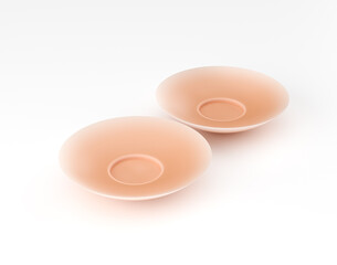 Pair of nude silicone nipple covers on white background for lingerie. 3d illustration