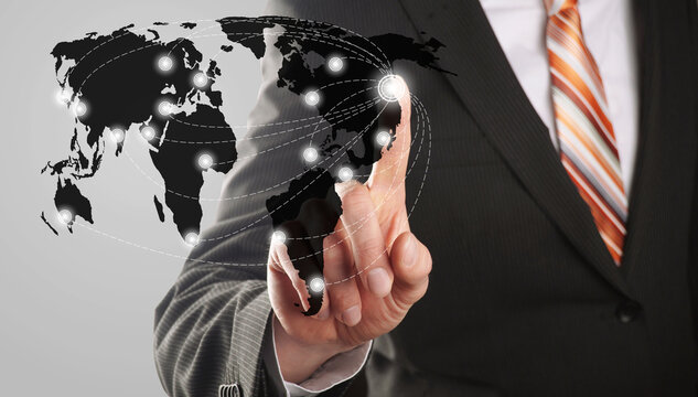 businessman touching digital world map with global connections