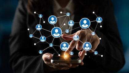 A person engages with a smartphone, showcasing a digital network with user icons, highlighting modern communication and social interaction concepts in technology. Tessel