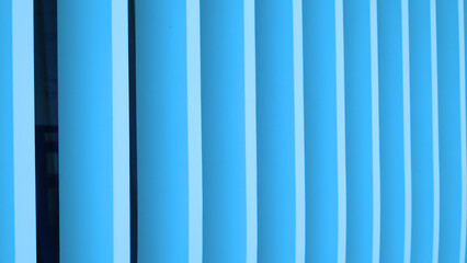 Modern blue architectural wall with vertical lines
