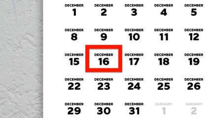 Close-up of the date December 16th marked with a red cursor on the wall calendar 2025