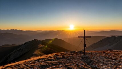 Cross on mountain peak at sunrise with sunburst - Powered by Adobe
