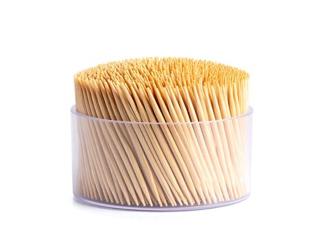 A clear container filled with wooden toothpicks, isolated on a white background