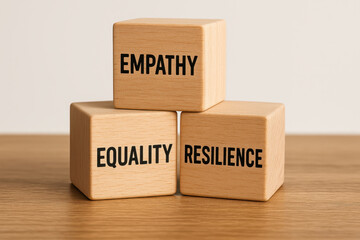 Wooden blocks with words empathy equality and resilience symbolize core values of business ethics promoting fairness and strength in professional environments