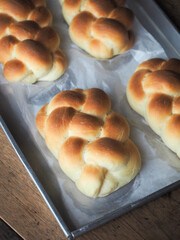 golden brown baked braided bread in baking tray