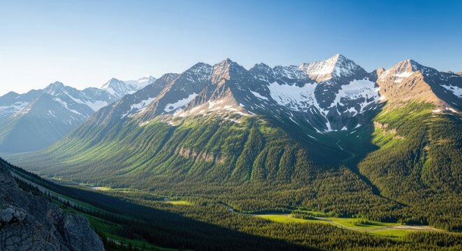 Stunning mountain range with snow-capped peaks and lush green valley offers an inspirational landscape ideal for adventure, travel, or environmental themes evoking peace and serenity