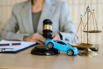 Lawyer working with justice scale and gavel on desk, representing law, fairness, and legal consultation in an office environment.