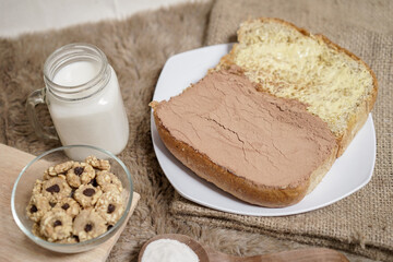 Bread with choco powder and butter on a plate for breakfast	
