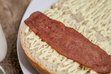 Bread with smoked beef on a plate for breakfast and coffee break	
