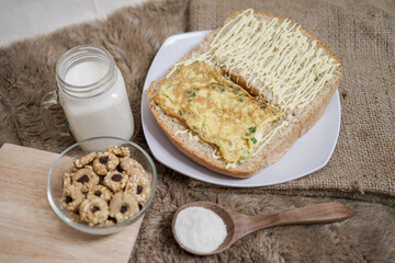 Bread with scrambled egg sandwich on a plate for breakfast and coffee break	
