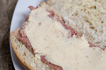 Bread with smoked beef and mozarella cheese on a plate for fast food breakfast or coffee break.	
