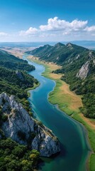 Obraz premium Serene Wide Valley with Flowing River and Lush Greenery Under a Bright Blue Sky with White Clouds