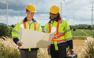 Two men in safety gear are looking at  piece of paper