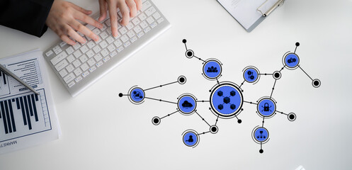 A close-up view of a person hands typing on a keyboard with a creative graphical representation of...