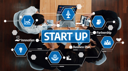 Aerial view of a modern business meeting focused on startup growth, featuring charts, partnership...