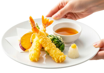 Hand holding a plate of delicious tempura with dipping sauce isolated on transparent background
