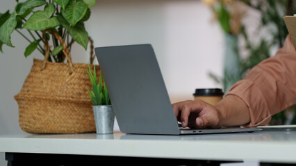 Focused Professional. Man working on laptop in a modern office setting.