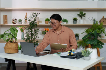 Productive Workspace. Professional organizing documents and using laptop.