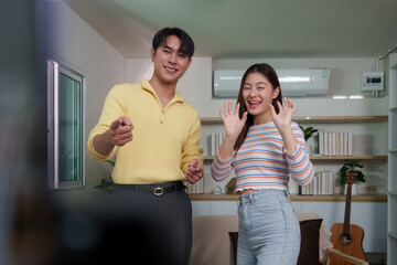 Social Media Influencers Engaging with Audience in Home Studio