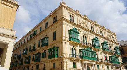 Fototapeta premium View of old building with windows, balconies in city. Republic of Malta, the picturesque city of Valetta, Malta.