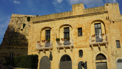 Fototapeta premium View of old building with windows, balconies in city. Republic of Malta, the picturesque city of Valetta, Malta.