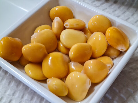 Close-up of Pickled Lupini Beans (Lupinus Albus) in a White Square Bowl.