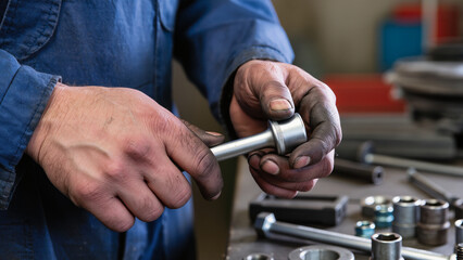 close up of a man holding a wrench