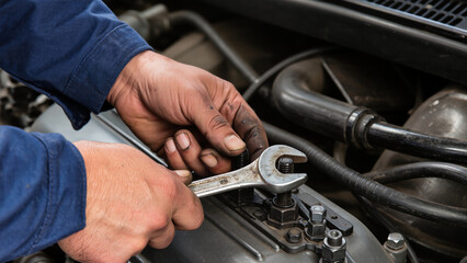 mechanic changing car engine