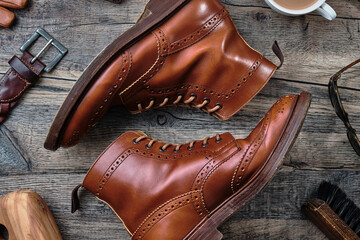 Wingtip Brogue Boots and Accessories on Wooden Table