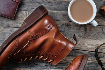 Wingtip Brogue Boots and Accessories on Wooden Table