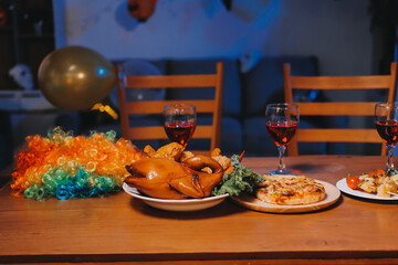 Joyful office Halloween party with coworkers in costumes, celebrating with drinks and laughter,...