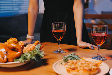 Joyful office Halloween party with coworkers in costumes, celebrating with drinks and laughter,...