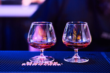 Luxury cognac glasses in warm lighting