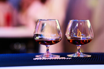 Luxury cognac glasses in warm lighting