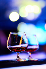 Luxury cognac glasses in warm lighting